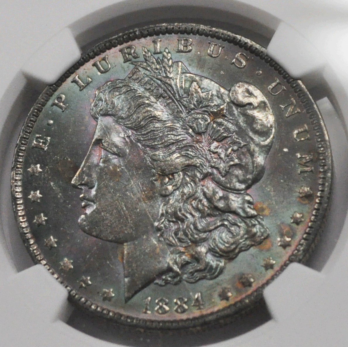 1884 O $1 Morgan Silver One Dollar MS63 NGC Roller Mark Dissecting Toned Obverse